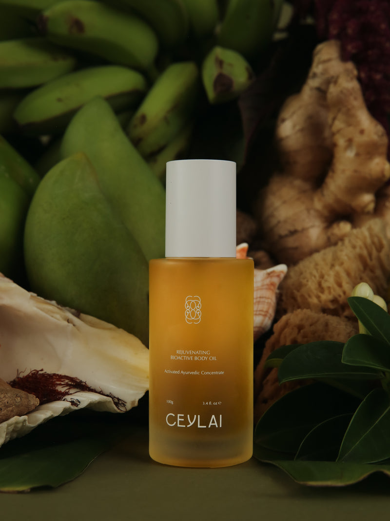 Ceylai body oil bottle with natural ingredients, bananas and ginger in the background