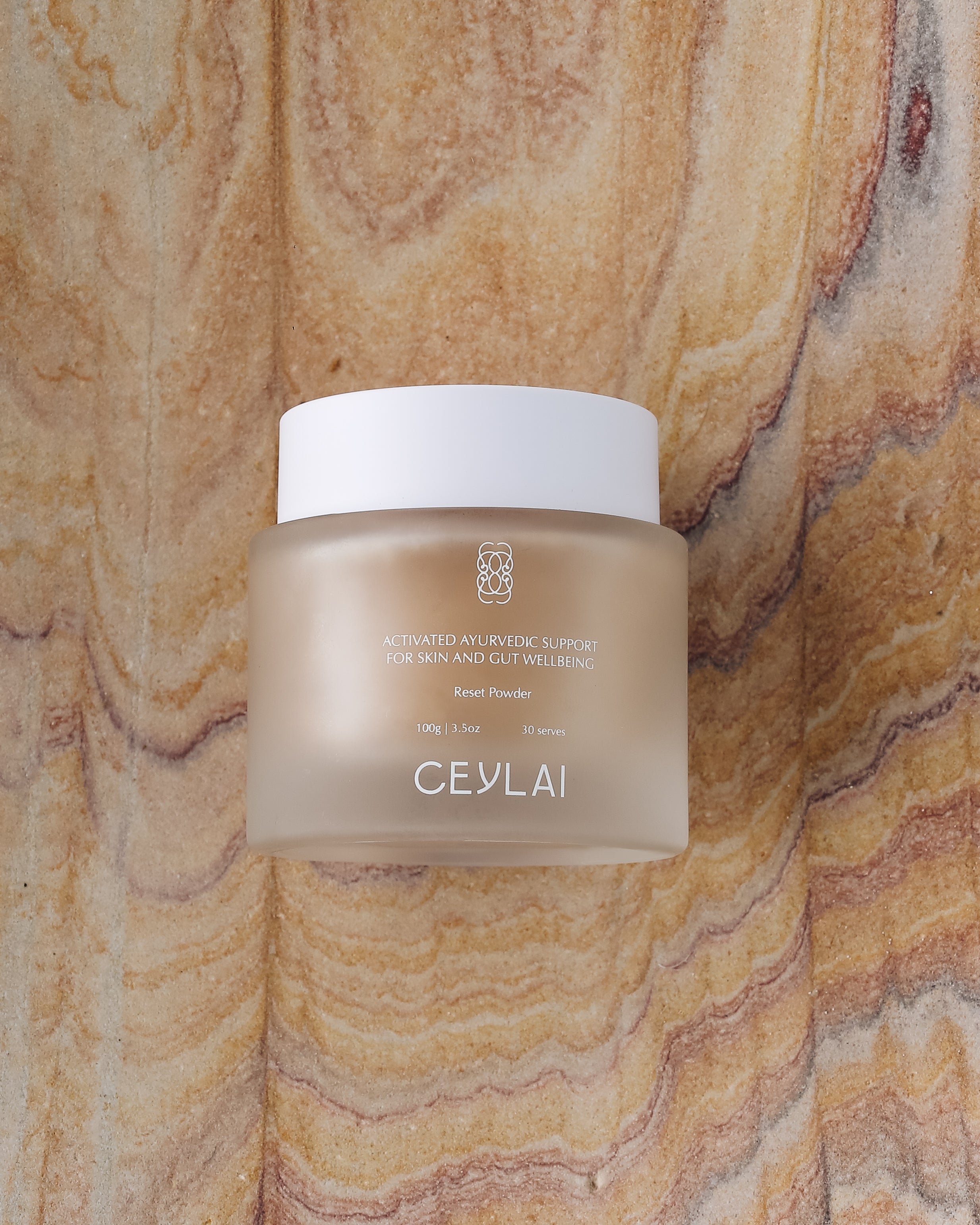 Ceylai Reset Powder jar on a sandstone background