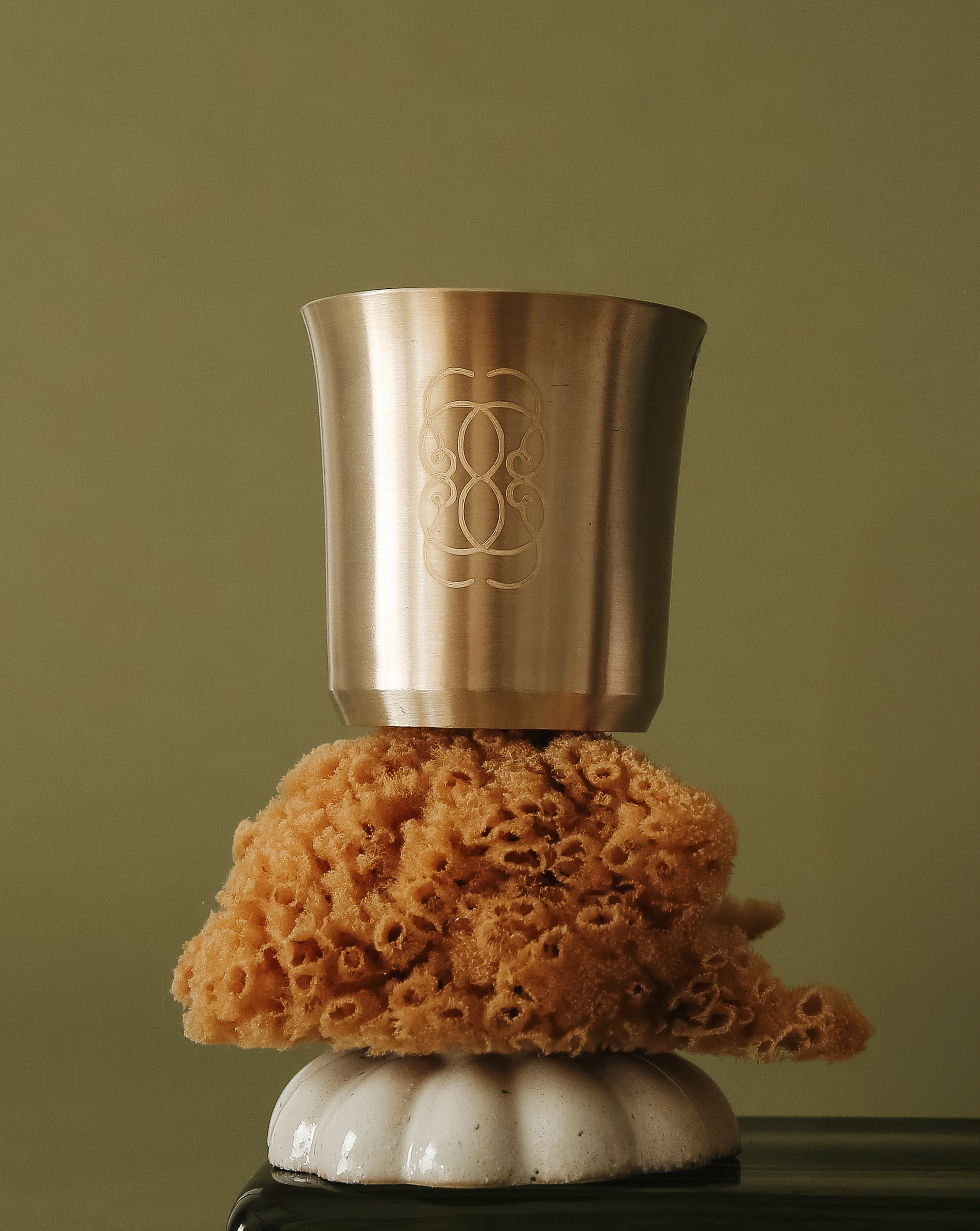 Bronze cup on a sea sponge with a green background.
A handcrafted Kansa vessel for daily nourishment and ritual.
The CEYLAI Kansa Ritual Cup is crafted from pure Kansa, a traditional bronze alloy long used in Ayurvedic living. Handcrafted by artisans, each cup carries subtle variations in tone and texture, reflecting the beauty of a material shaped slowly, with care and intention. Designed to be used with the CEYLAI Reset Powder, the cup transforms a simple drink into a moment of ritual.
